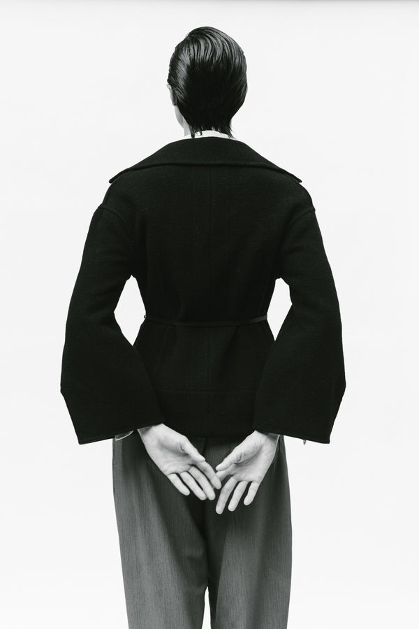 model wearing pink sweater with white wide sleeve