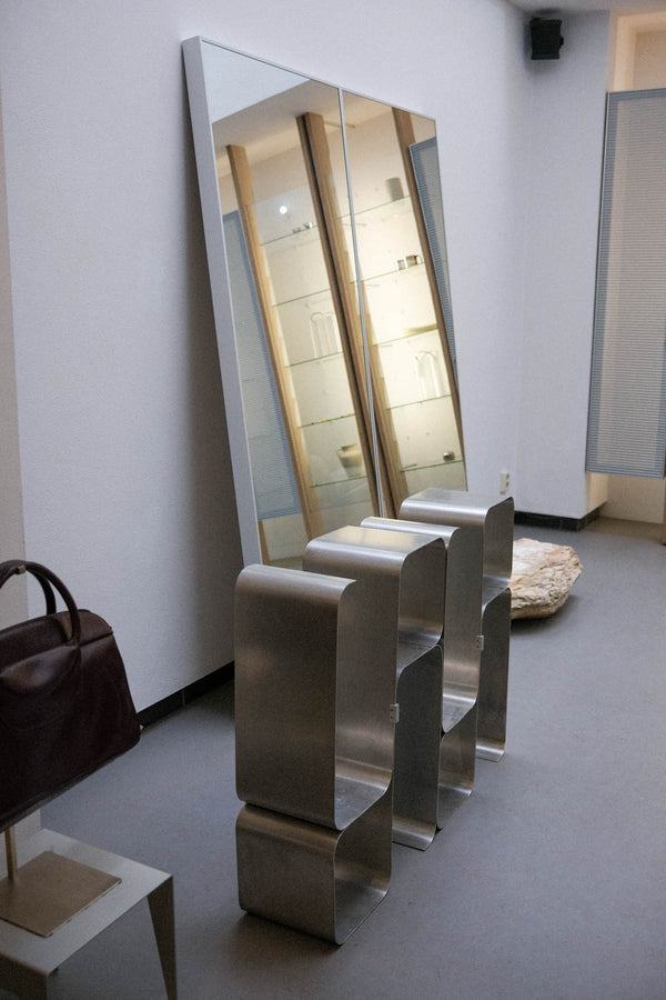 enso store photo showcasing a metal cabinet with big mirror and a bag