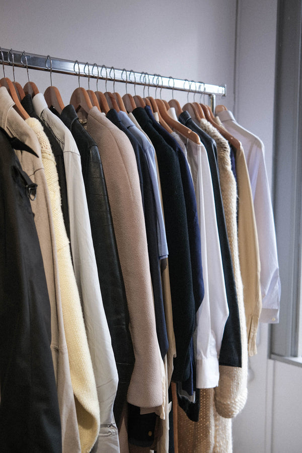 iage of enso store amsterdam clothing rack showcasing delicate silk, leather jackets in black and cream shades and some wool coats